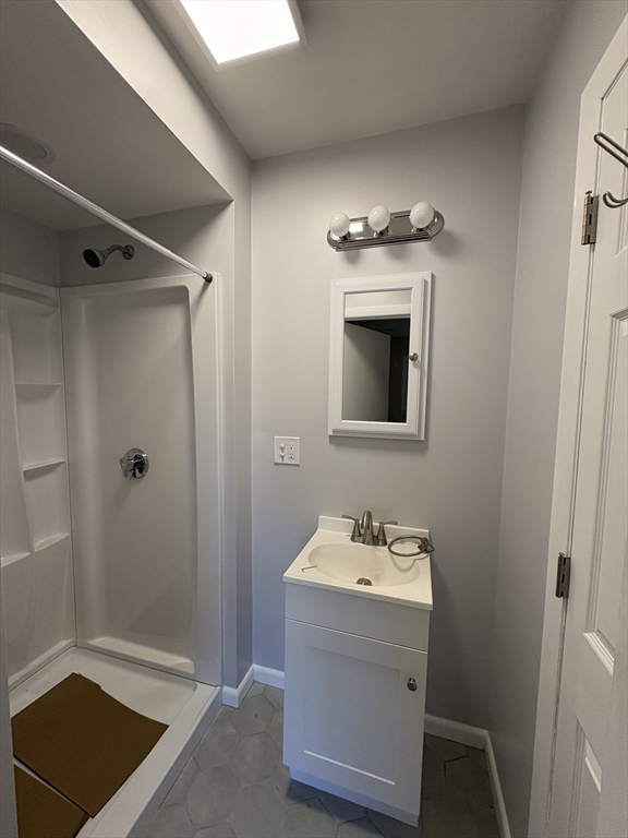150 West Wrentham Road Cumberland, RI 02864 - Photo 16 of 38 a bathroom with a sink a toilet and shower