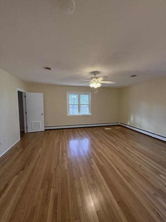 150 West Wrentham Road Cumberland, RI 02864 - Photo 19 of 38 a view of empty room with wooden floor and fan