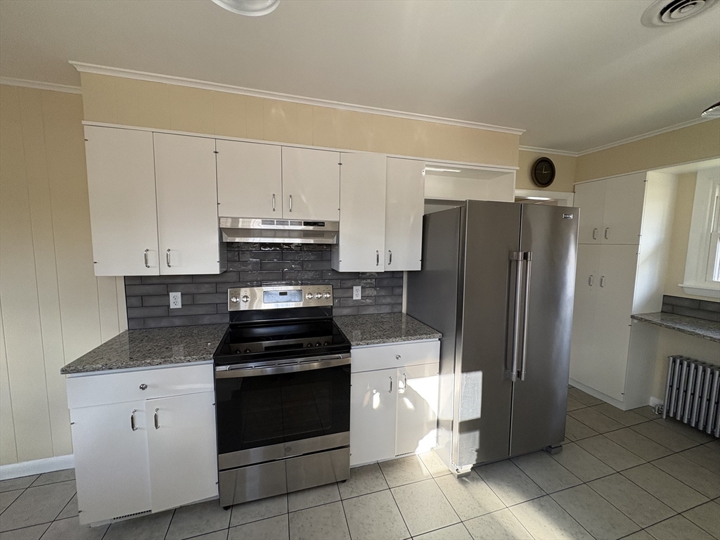 150 West Wrentham Road Cumberland, RI 02864 - Photo 2 of 38 a kitchen with a stove a refrigerator and cabinets