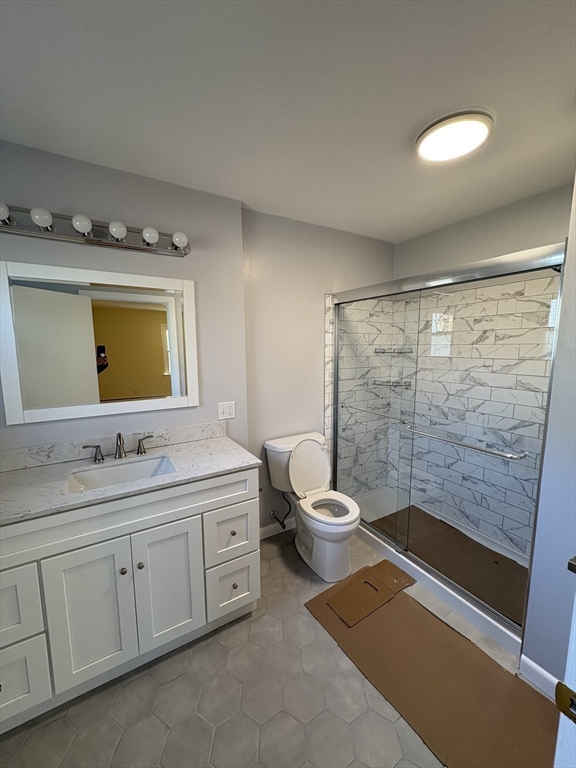 150 West Wrentham Road Cumberland, RI 02864 - Photo 21 of 38 a bathroom with a toilet a sink a mirror a shower a vanity and window