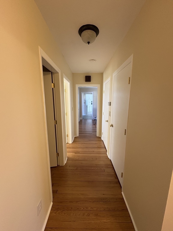 150 West Wrentham Road Cumberland, RI 02864 - Photo 22 of 38 a view of a hallway with wooden floor and staircase