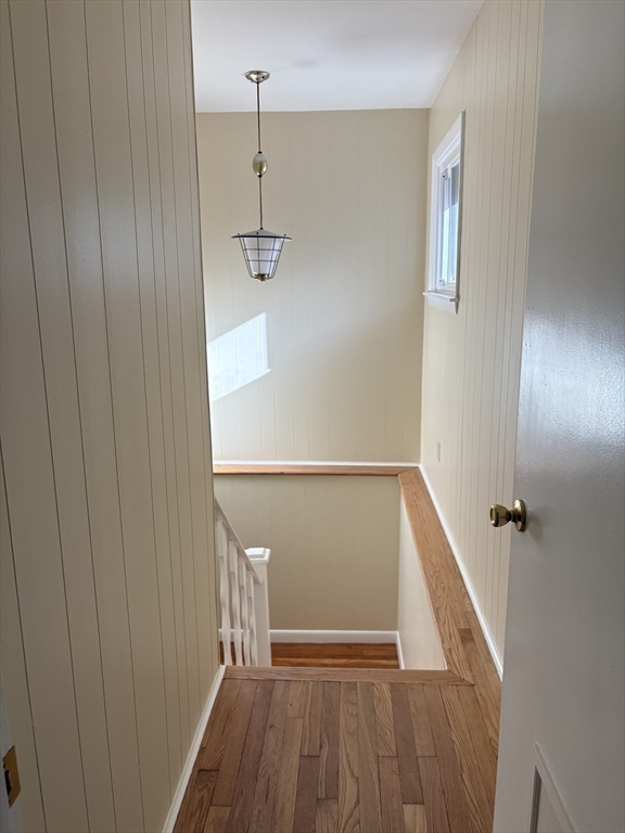 150 West Wrentham Road Cumberland, RI 02864 - Photo 23 of 38 a view of a hallway with wooden floor and staircase