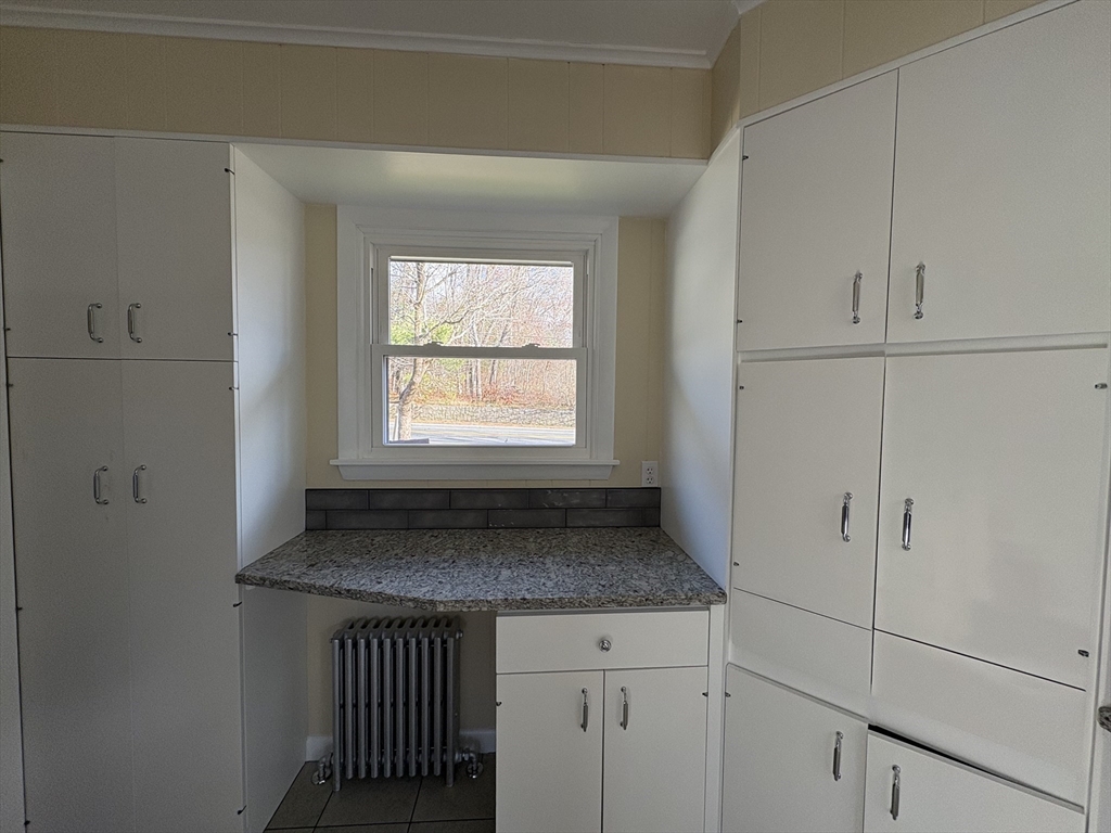 150 West Wrentham Road Cumberland, RI 02864 - Photo 3 of 38 a kitchen with granite countertop cabinets appliances and a window