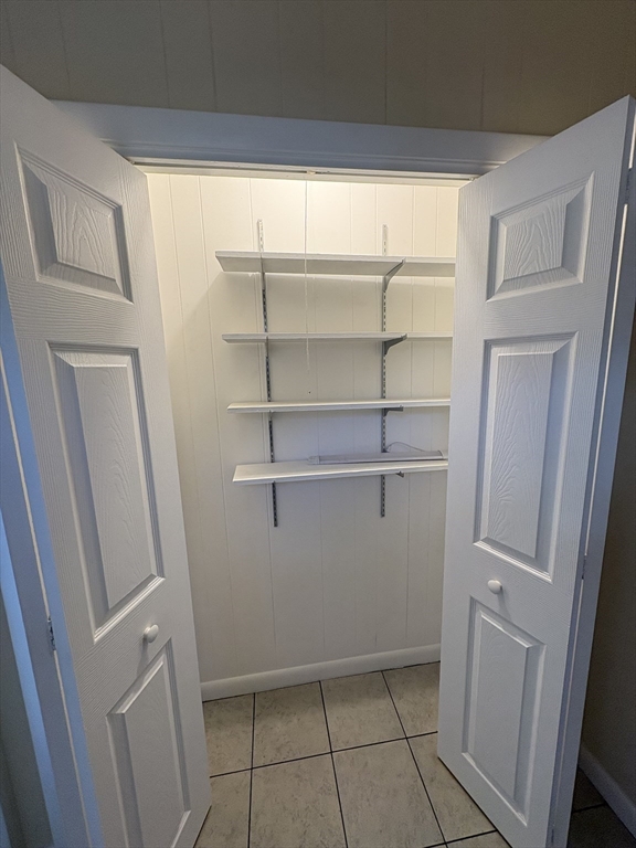 150 West Wrentham Road Cumberland, RI 02864 - Photo 5 of 38 a view of storage and utility room with empty racks