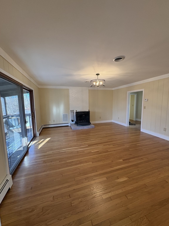 150 West Wrentham Road Cumberland, RI 02864 - Photo 6 of 38 a view of empty room with wooden floor and fan