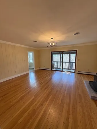 a view of a porch with furniture and wooden floor