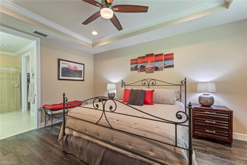 20191 Torch Key Way Estero, FL 33928 - Photo 15 of 39 a bedroom with a bed and a chandelier