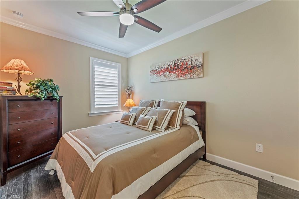 20191 Torch Key Way Estero, FL 33928 - Photo 20 of 39 a bedroom with a bed and a chandelier