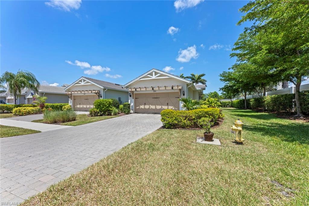 20191 Torch Key Way Estero, FL 33928 - Photo 2 of 39 a front view of a house with a yard