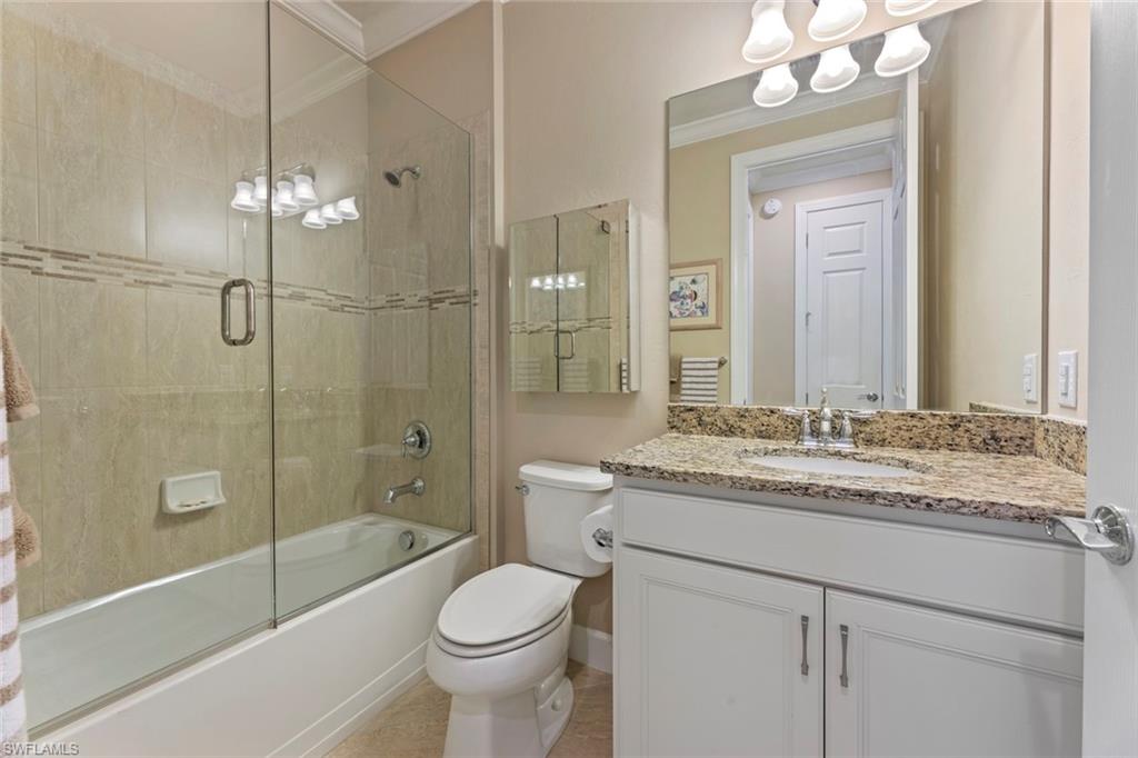 20191 Torch Key Way Estero, FL 33928 - Photo 21 of 39 a bathroom with a granite countertop sink toilet mirror and shower
