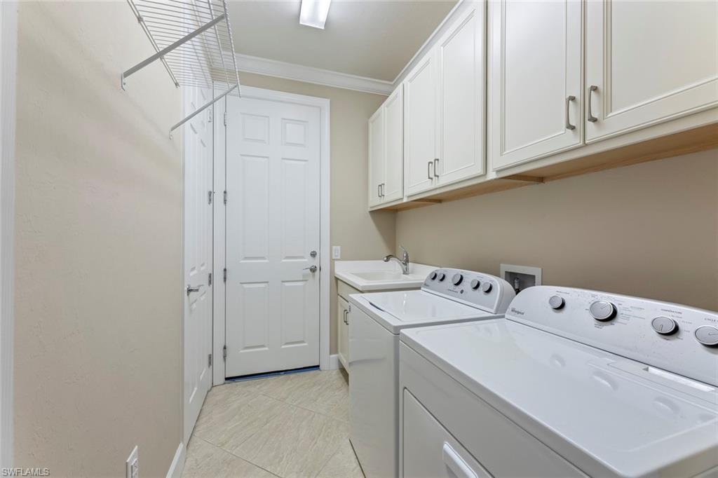 20191 Torch Key Way Estero, FL 33928 - Photo 22 of 39 a utility room with dryer and washer