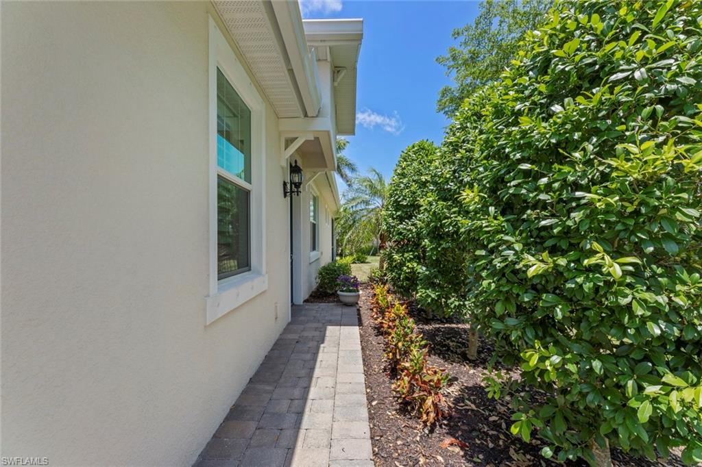 20191 Torch Key Way Estero, FL 33928 - Photo 3 of 39 a view of a pathway of a house with potted plants