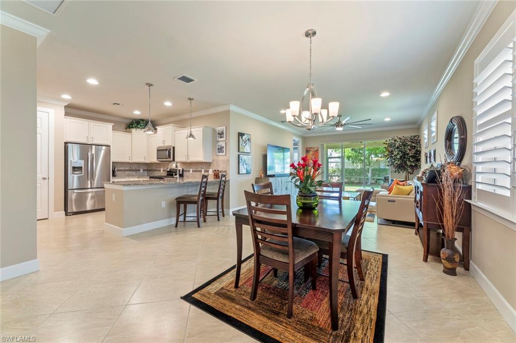 20191 Torch Key Way Estero, FL 33928 - Photo 4 of 39 a view of a dining room with furniture and chandelier