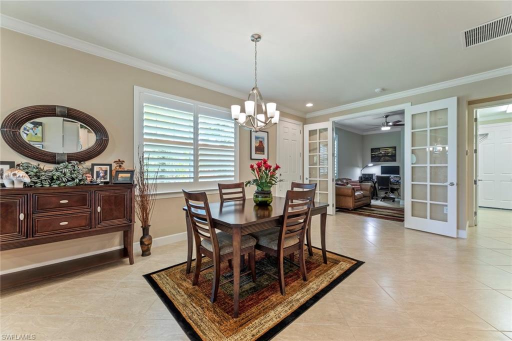 20191 Torch Key Way Estero, FL 33928 - Photo 5 of 39 a dining room with furniture a window and a chandelier
