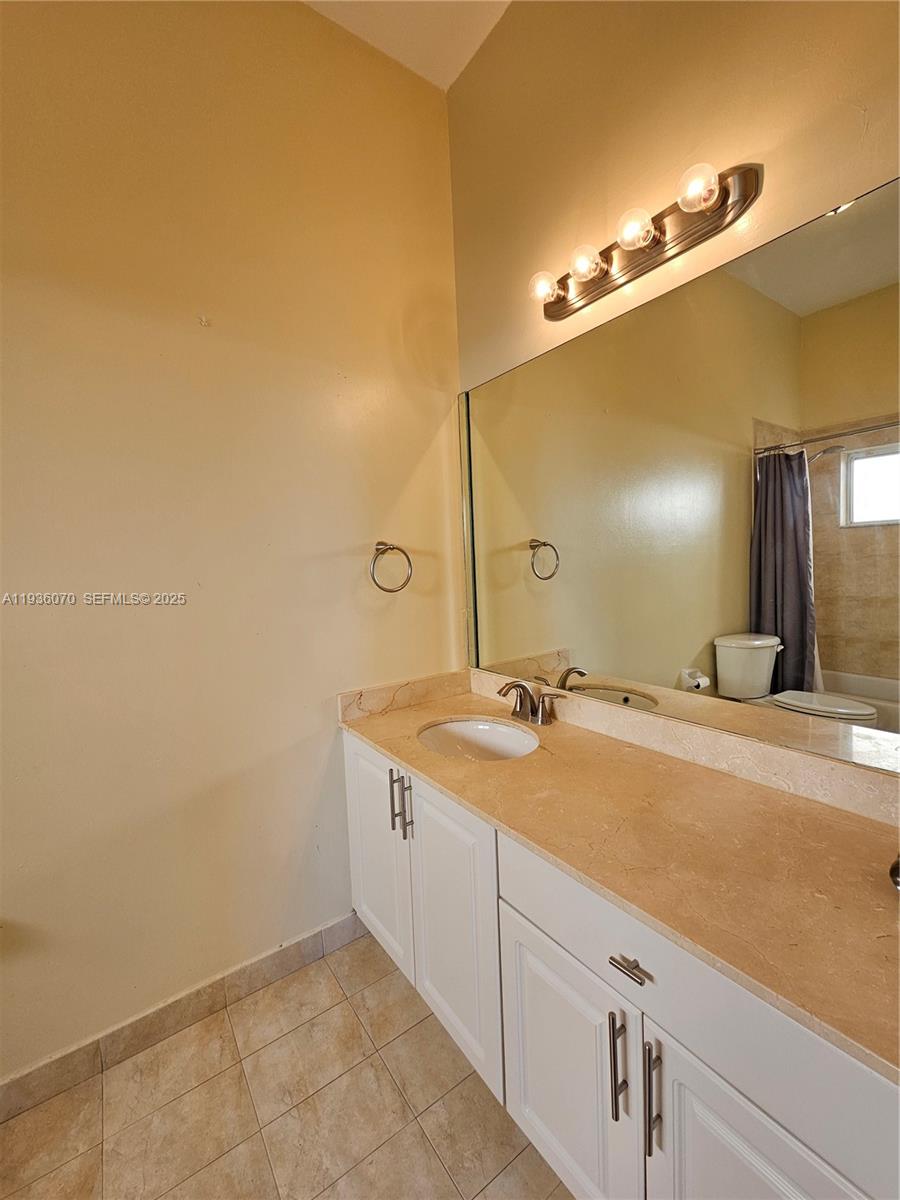 14209 Southwest 160th Court Miami, FL 33196 - Photo 9 of 24 a bathroom with a sink and a mirror