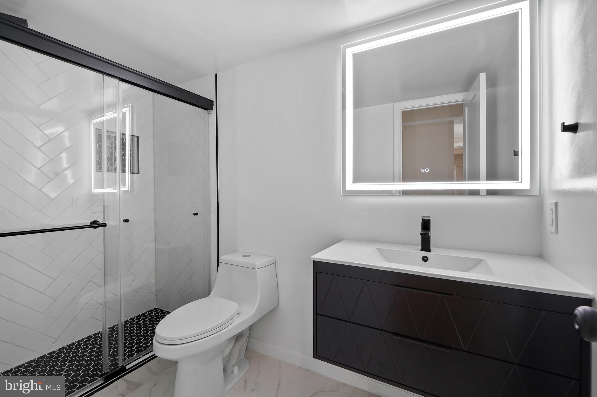 7661 Provincial Drive, Unit 112 McLean, VA 22102 - Photo 12 of 36 a bathroom with a sink toilet and vanity