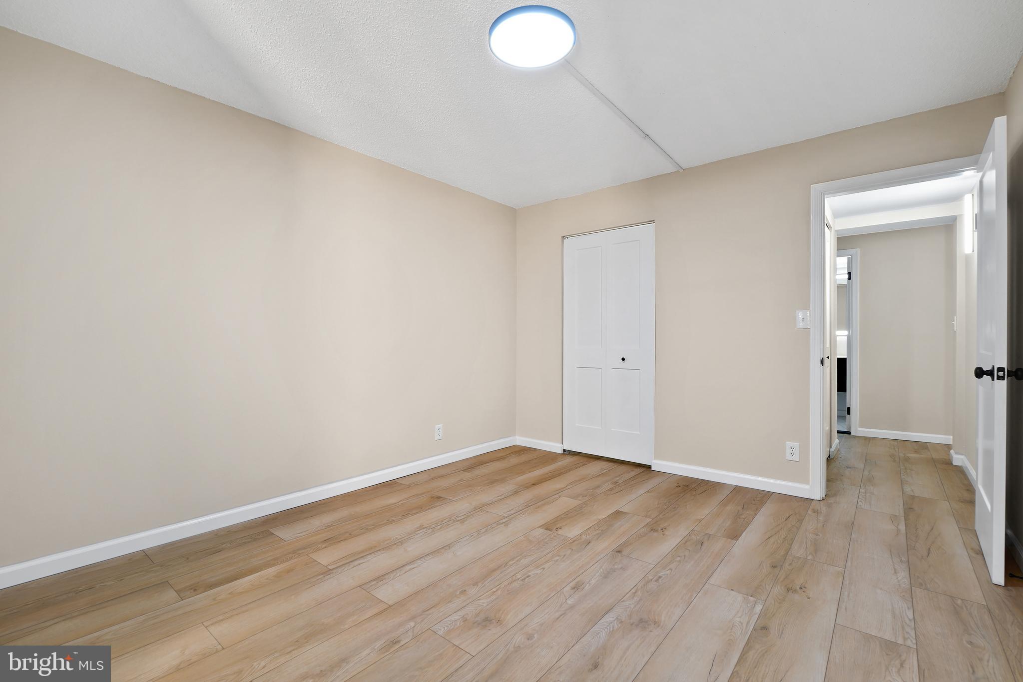 7661 Provincial Drive, Unit 112 McLean, VA 22102 - Photo 14 of 36 a view of an empty room with wooden floor