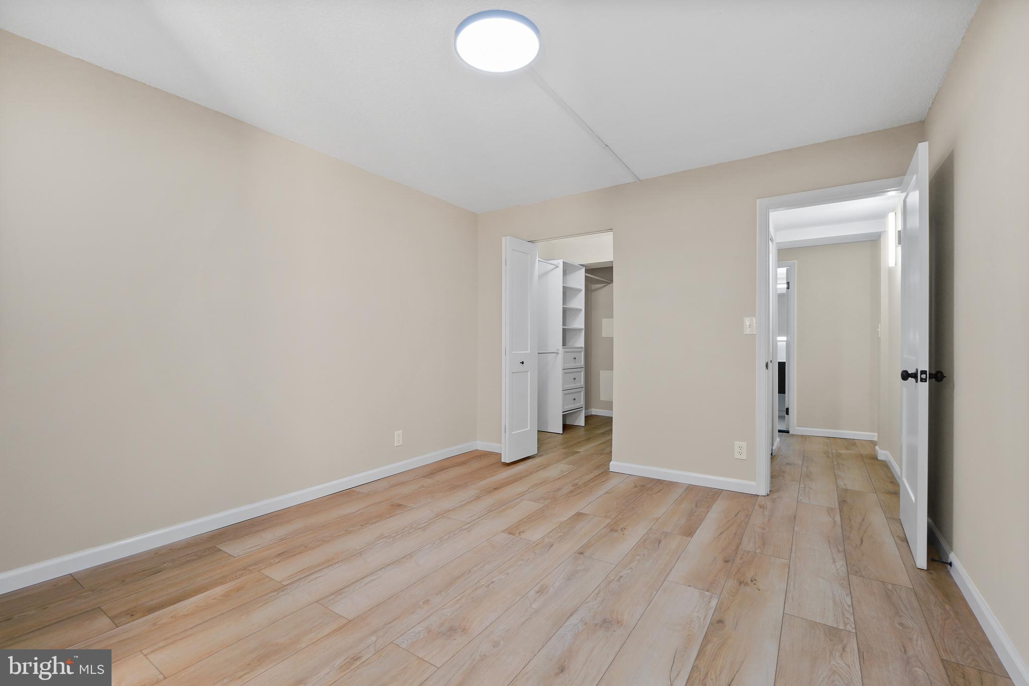 7661 Provincial Drive, Unit 112 McLean, VA 22102 - Photo 16 of 36 a view of an empty room with wooden floor