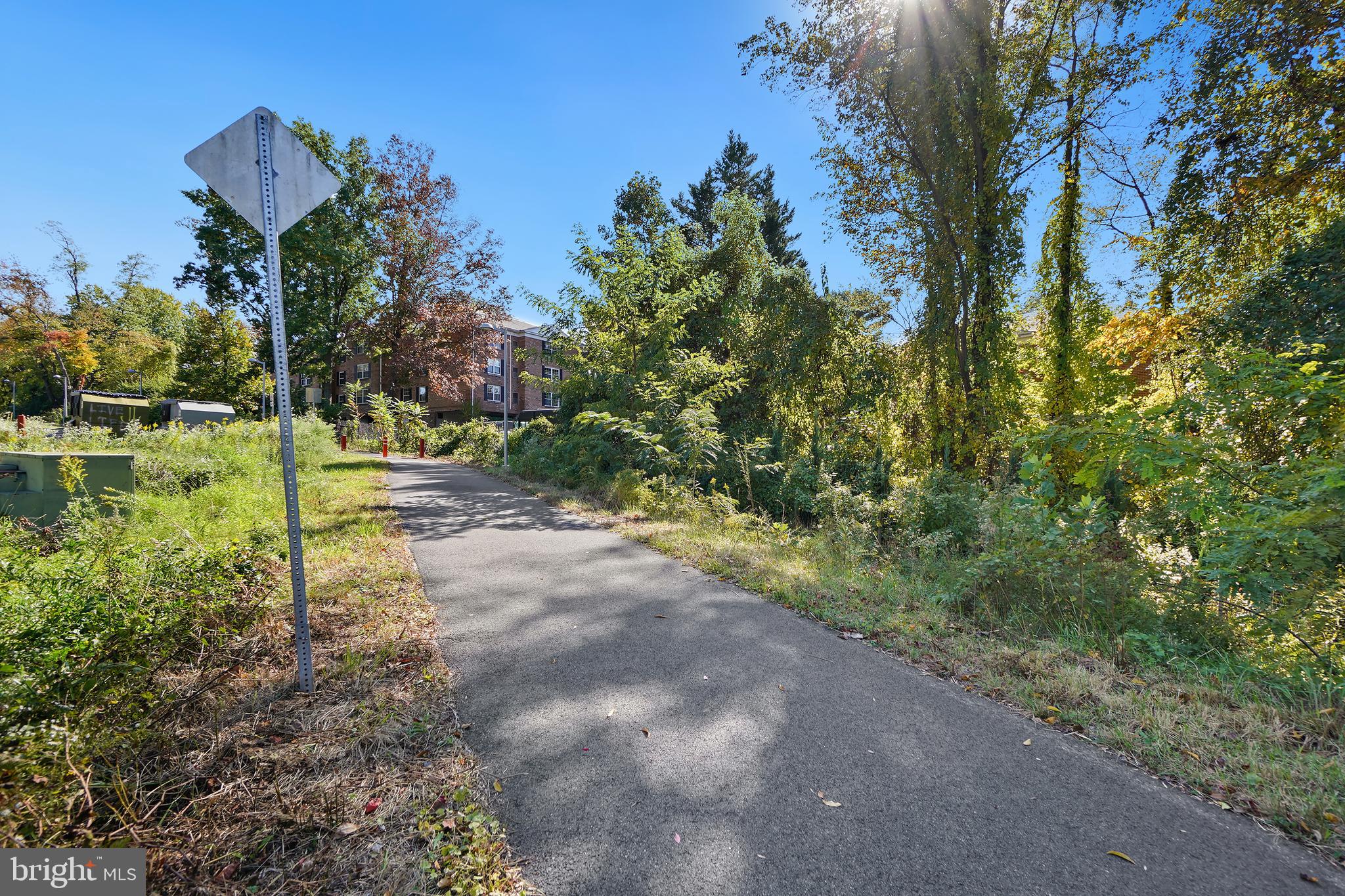 7661 Provincial Drive, Unit 112 McLean, VA 22102 - Photo 27 of 36 a view of a yard with plants and a bench
