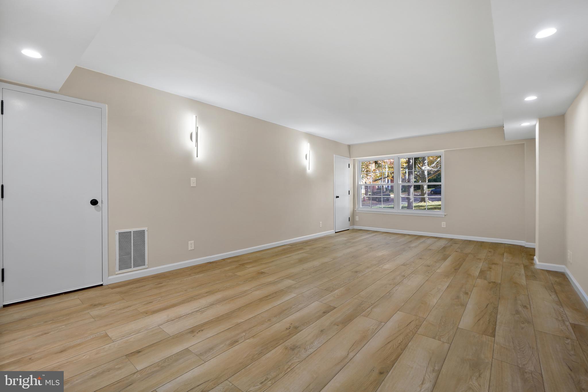 7661 Provincial Drive, Unit 112 McLean, VA 22102 - Photo 3 of 36 an empty room with wooden floor and windows