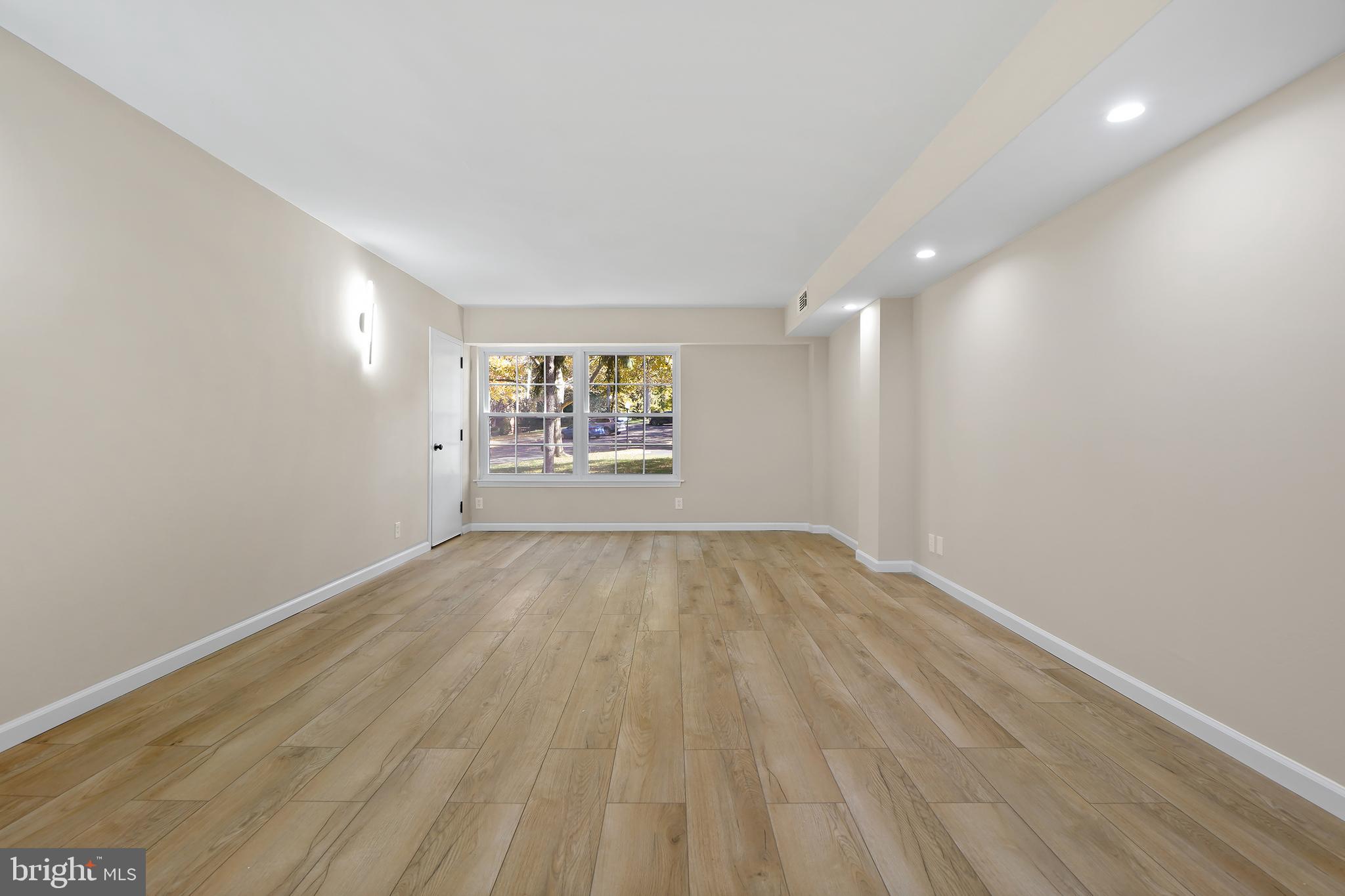7661 Provincial Drive, Unit 112 McLean, VA 22102 - Photo 4 of 36 an empty room with wooden floor and windows