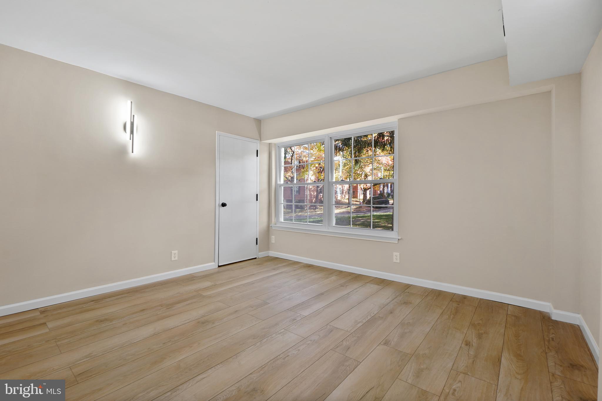 7661 Provincial Drive, Unit 112 McLean, VA 22102 - Photo 6 of 36 a view of an empty room with wooden floor and a window