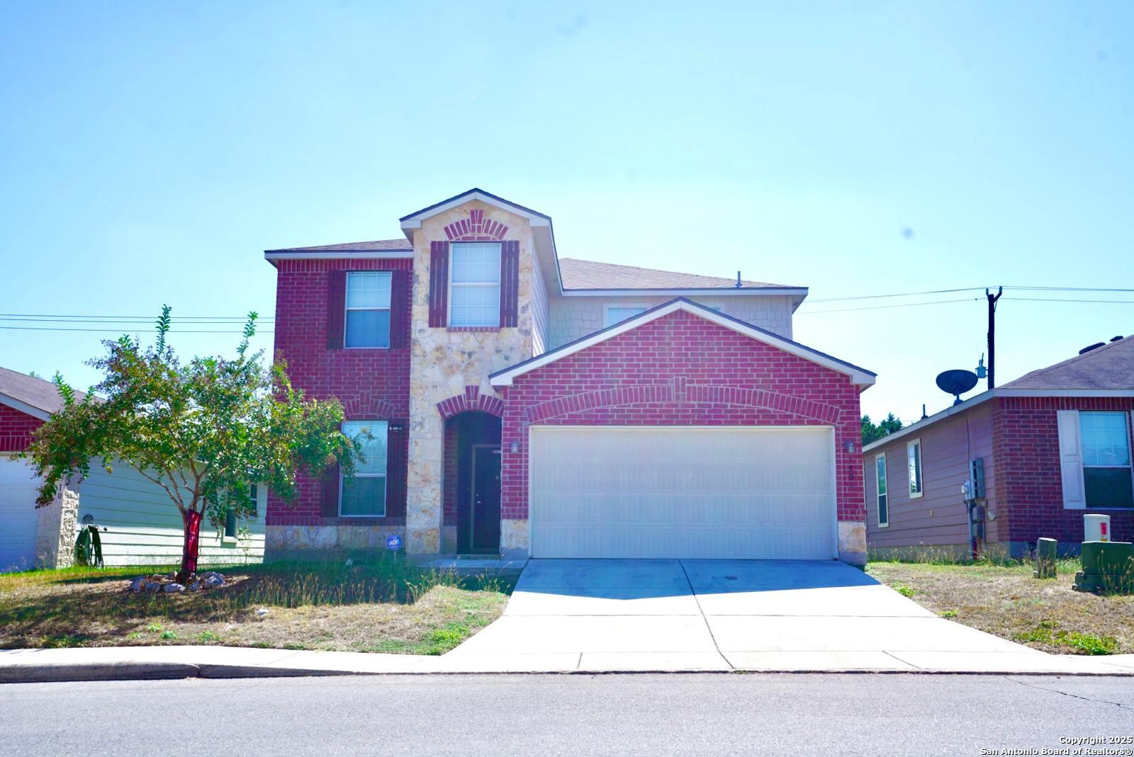 a front view of a house with a yard and garage