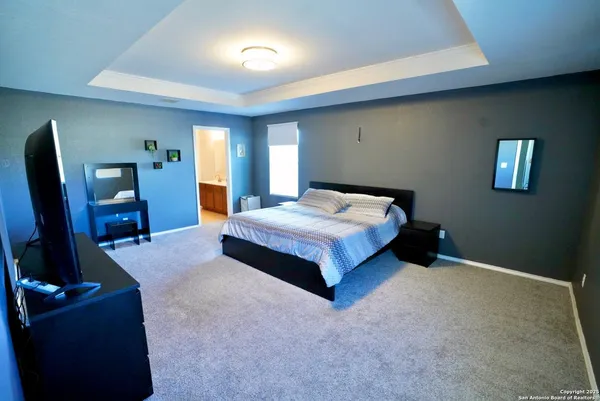 a bedroom with a bed and a flat screen television