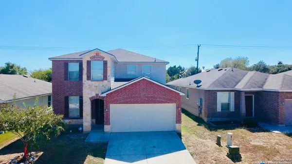 a aerial view of a house next to a yard