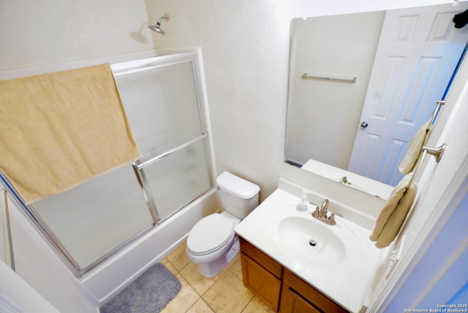 3906 Bent Grass San Antonio, TX 78261 - Photo 22 of 23 a white toilet sitting next to a bathroom sink