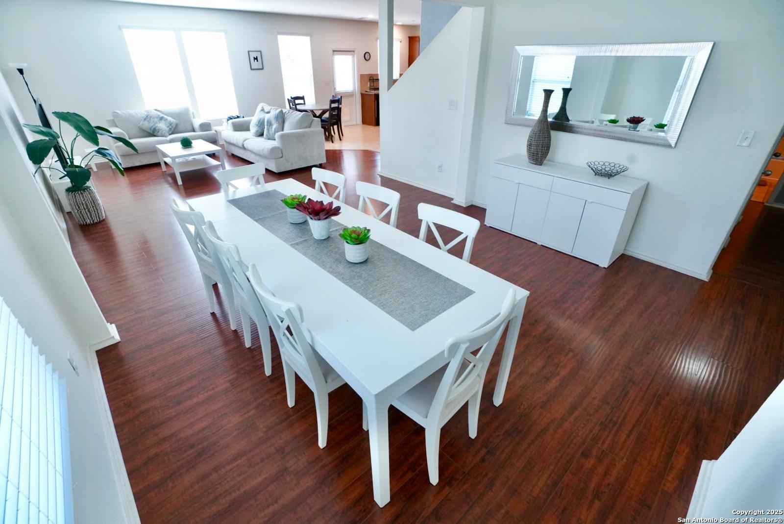 3906 Bent Grass San Antonio, TX 78261 - Photo 4 of 23 a view of a dining room with furniture and wooden floor