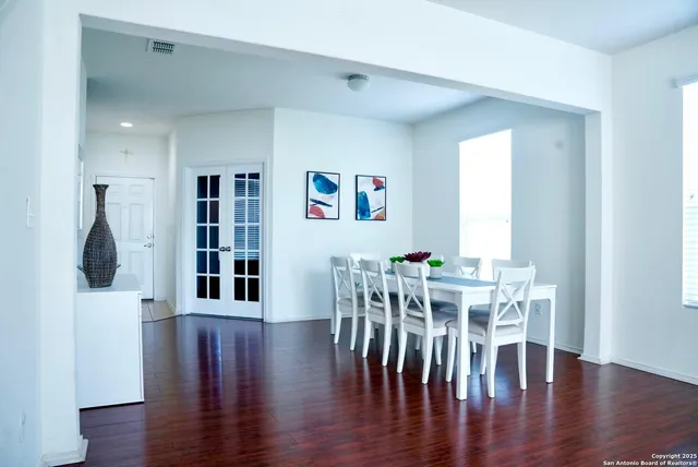 a view of a dining room with furniture and wooden floor