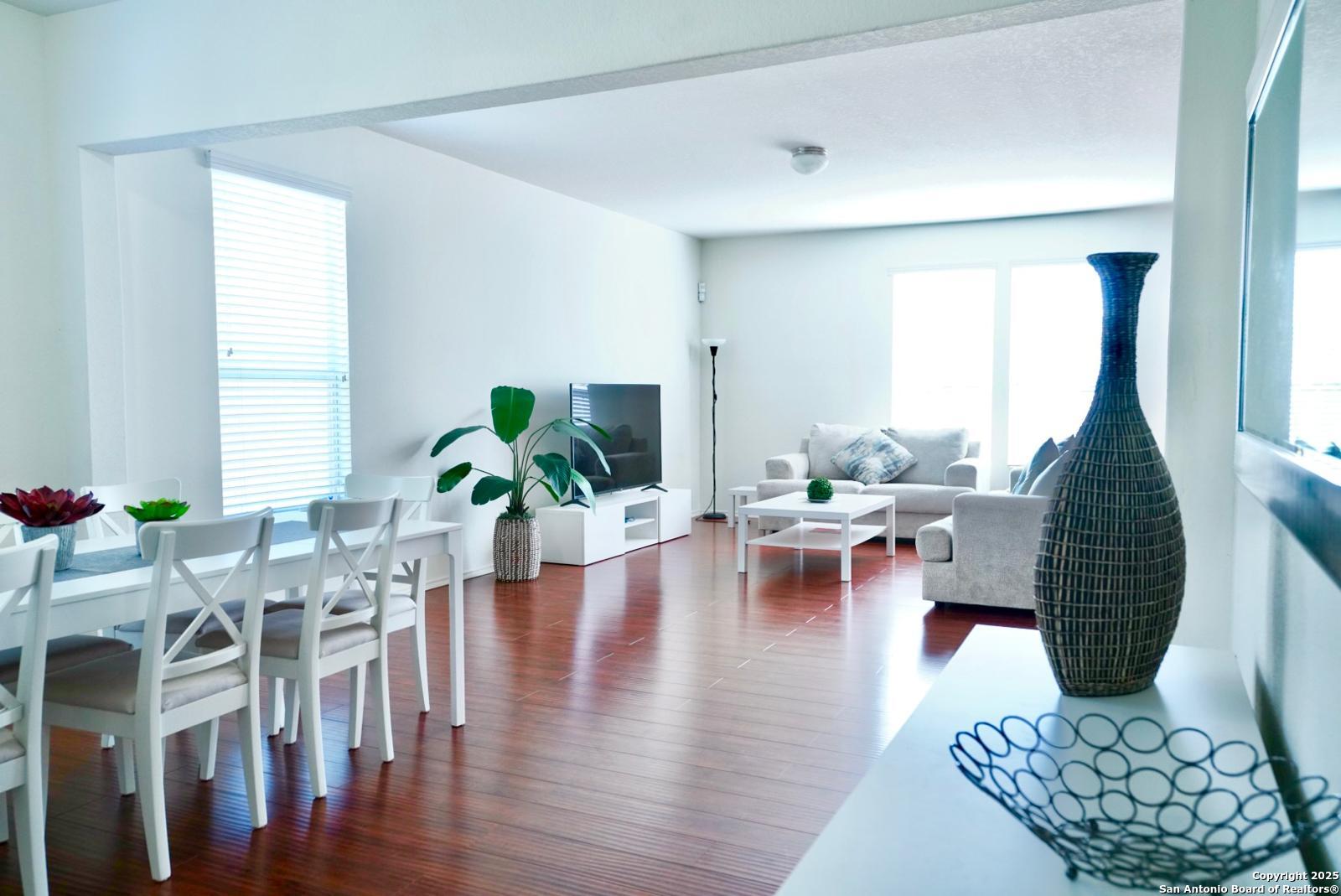 3906 Bent Grass San Antonio, TX 78261 - Photo 6 of 23 a living room with furniture floor to ceiling window and wooden floor