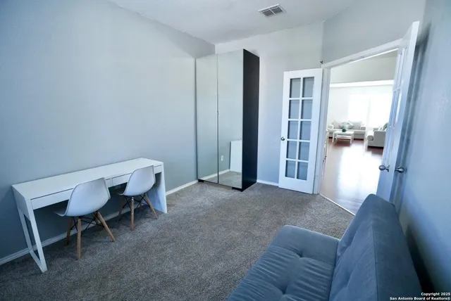 a view of a livingroom with furniture and a window