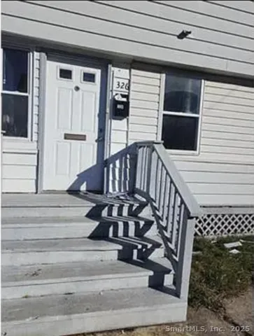 a view of entryway with wooden floor and a front door