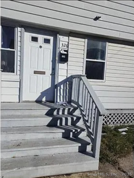 a view of entryway with wooden floor and a front door