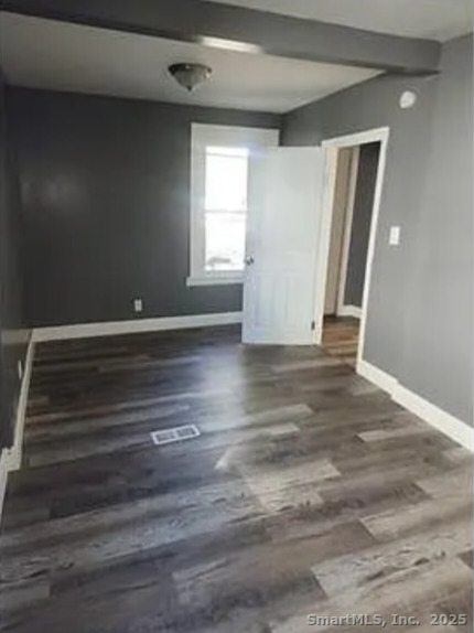 326 Wilmot Avenue Bridgeport, CT 06607 - Photo 3 of 4 a view of an empty room with wooden floor and a window