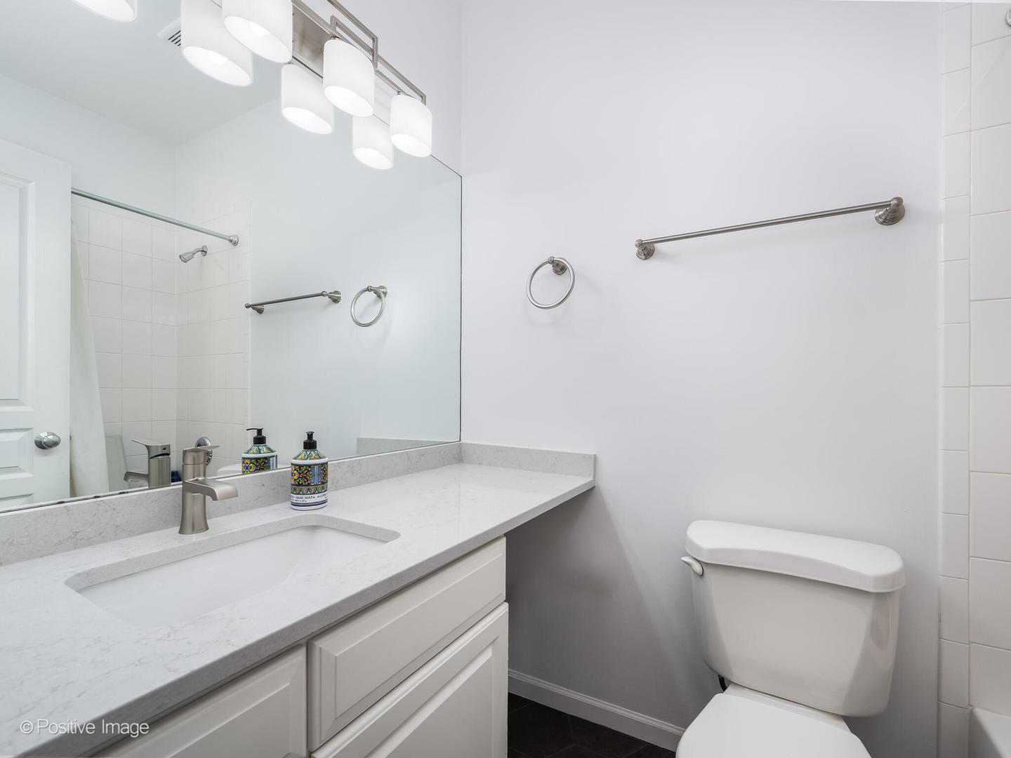 1645 West School Street, Unit 418 Chicago, IL 60657 - Photo 13 of 23 a bathroom with a sink toilet vanity and shower