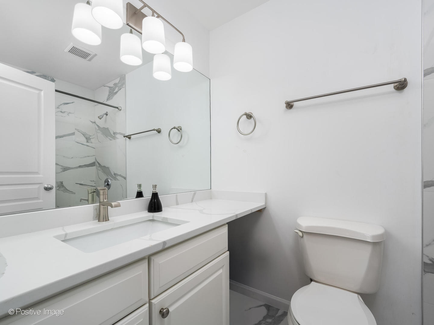 1645 West School Street, Unit 418 Chicago, IL 60657 - Photo 17 of 23 a bathroom with a sink a toilet and mirror