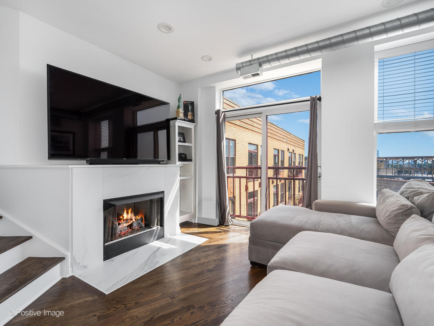 1645 West School Street, Unit 418 Chicago, IL 60657 - Photo 5 of 23 a living room with furniture and a fireplace