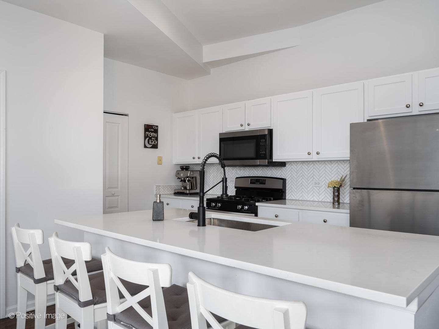 1645 West School Street, Unit 418 Chicago, IL 60657 - Photo 9 of 23 a kitchen with a white appliances a sink and a counter top space