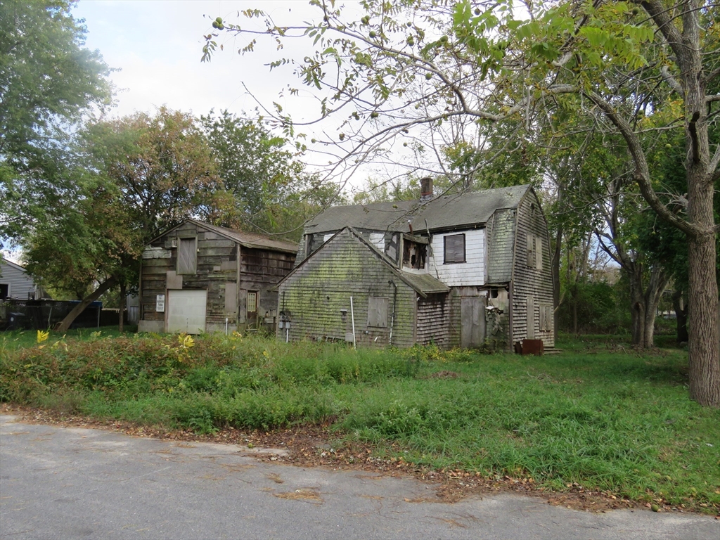 44 Bernard Street Acushnet, MA 02743 - Photo 5 of 7 a front view of a house with a garden
