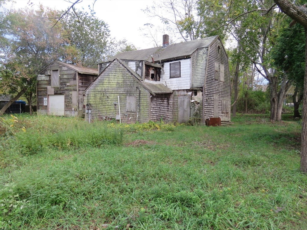 44 Bernard Street Acushnet, MA 02743 - Photo 6 of 7 a aerial view of a house next to a big yard and large trees