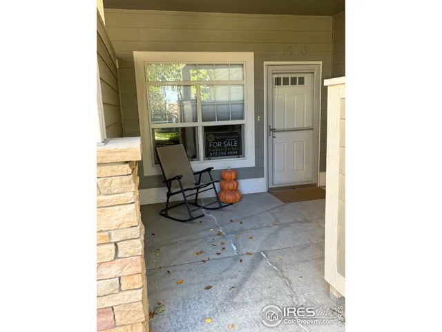 a view of a room with furniture and front door