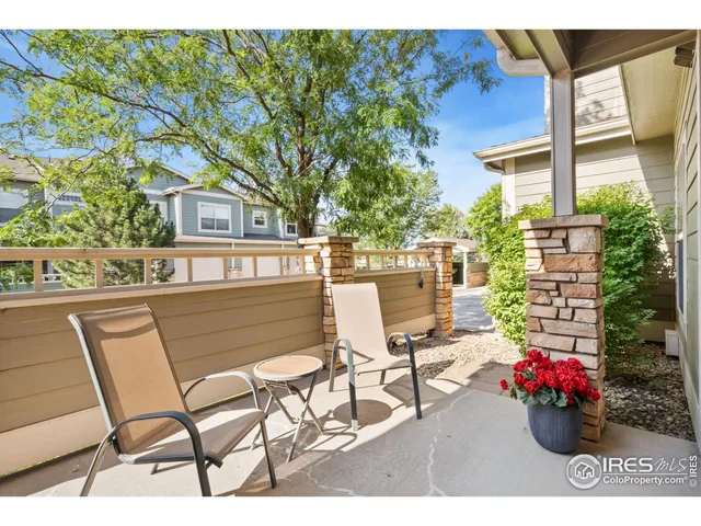 a view of a patio with table and chairs and potted plants