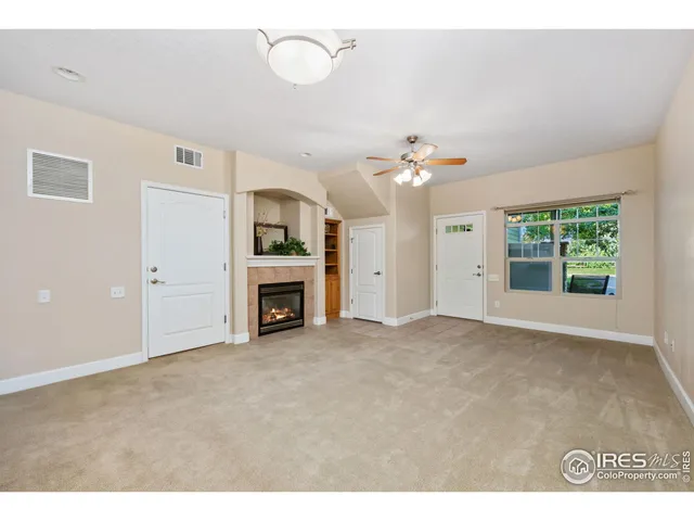 a view of an empty room with a fireplace