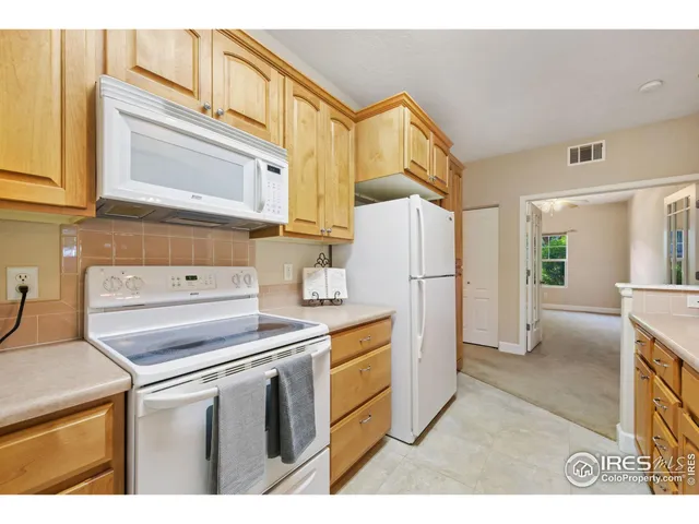 a kitchen with a refrigerator and a stove