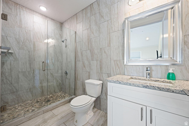 4281 Canterbury Road Hurricane, UT 84737 - Photo 22 of 24 Glass-enclosed shower with pebble flooring and tiled walls