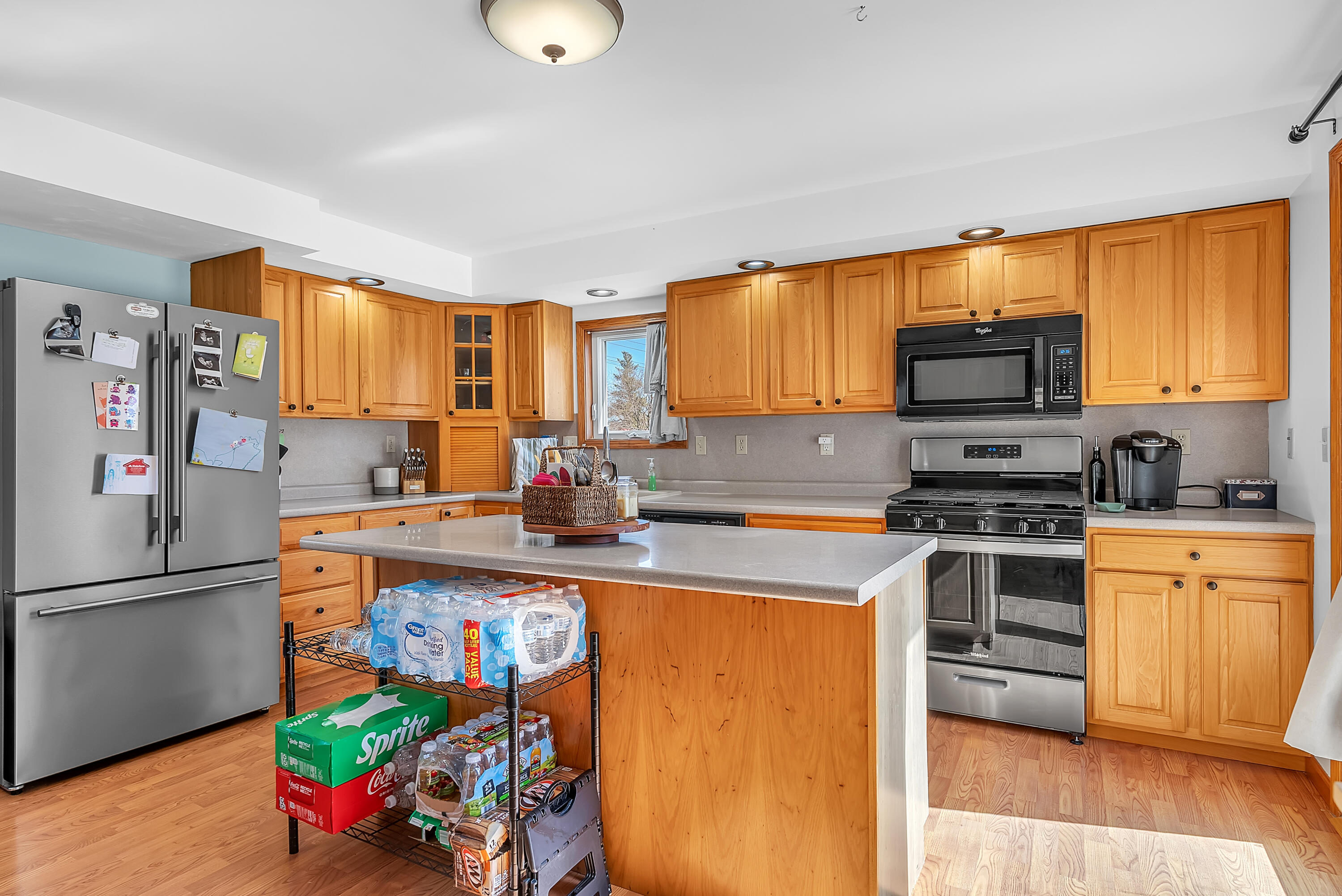 115 West Monroe Street Goodland, IN 47948 - Photo 11 of 36 a kitchen with stainless steel appliances granite countertop a refrigerator stove and a sink