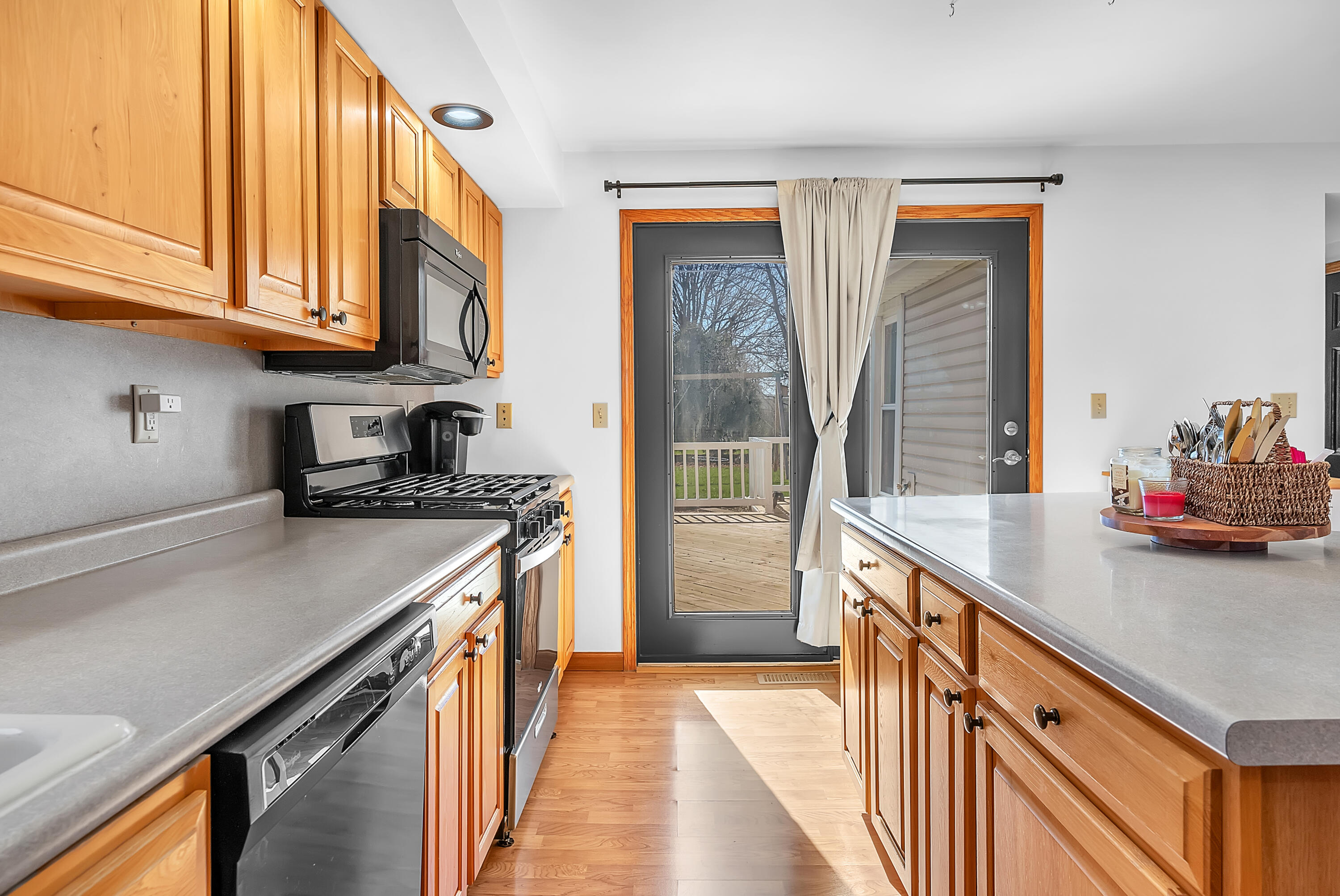 115 West Monroe Street Goodland, IN 47948 - Photo 12 of 36 a kitchen with stainless steel appliances granite countertop a sink a stove and a refrigerator